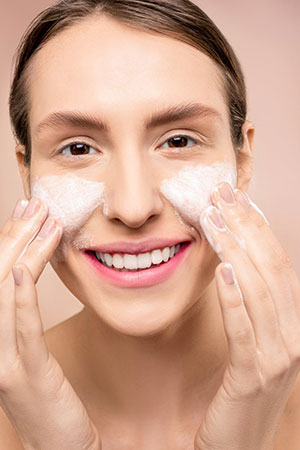 Woman exfoliating her face