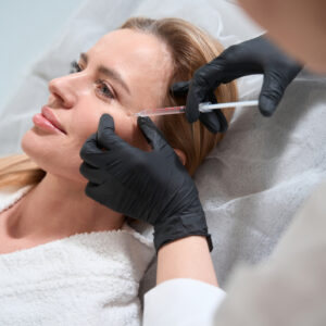Clous up of a dermatologist injecting botox or filler into a patient