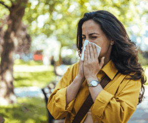 Woman outdoors having allergy