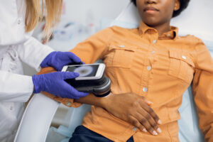 dermatologist inspecting to see if patient's skin cancer is curable
