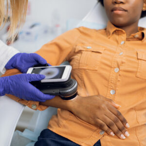 dermatologist inspecting to see if patient's skin cancer is curable