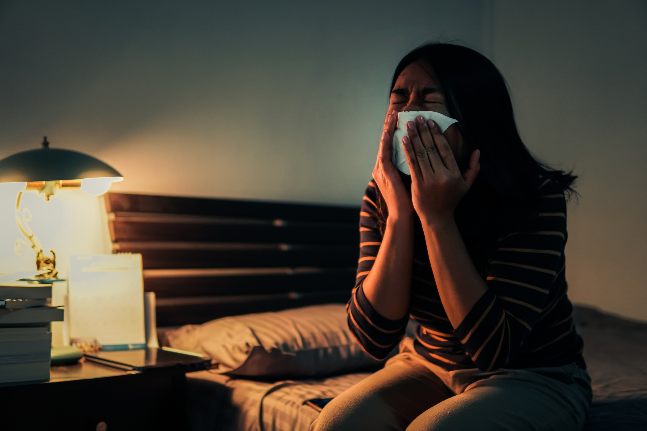 Sad Woman Crying While Sitting On Bed At HoME